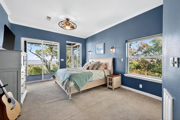 a bedroom with a bed and a large window