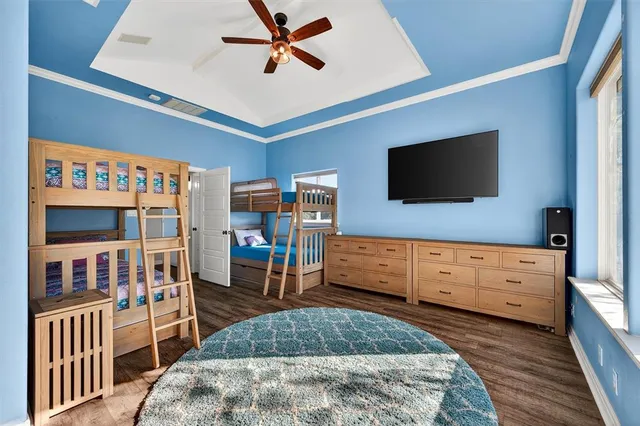 a bedroom with furniture and a flat screen tv