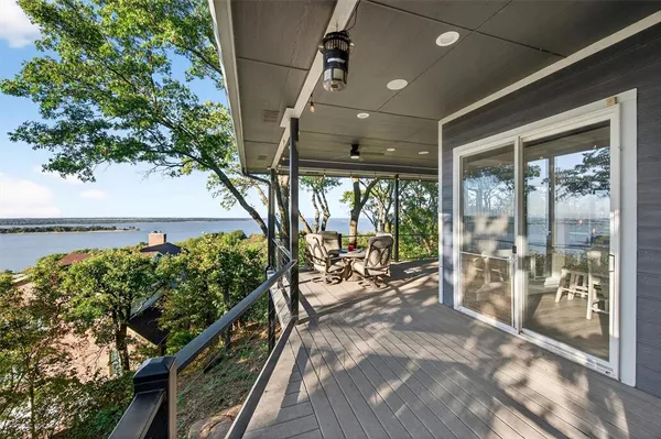a view of a patio with wooden floor and iron stairs