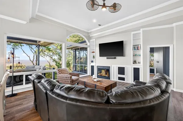 a living room with fireplace furniture and a flat screen tv