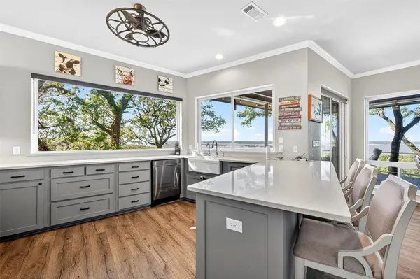 a kitchen with a stove a refrigerator and a table