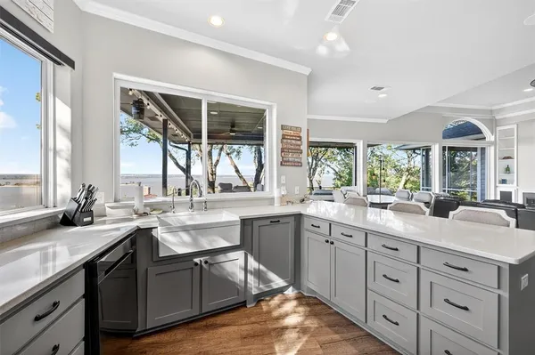 a kitchen with sink stove and cabinets