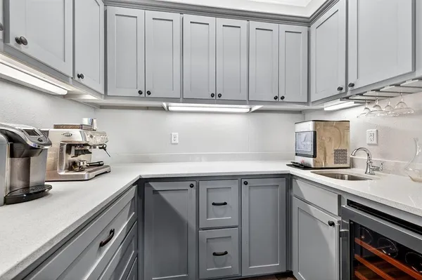 a kitchen with stainless steel appliances granite countertop a sink a stove and cabinets