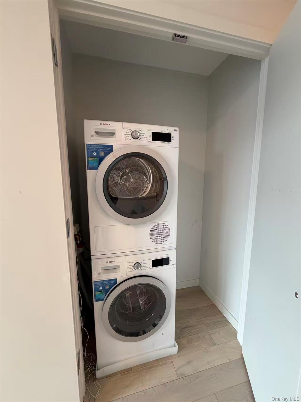 131-02 40th Road, Unit 7O Queens, NY 11354 - Photo 4 of 7 a utility room with dryer and washer