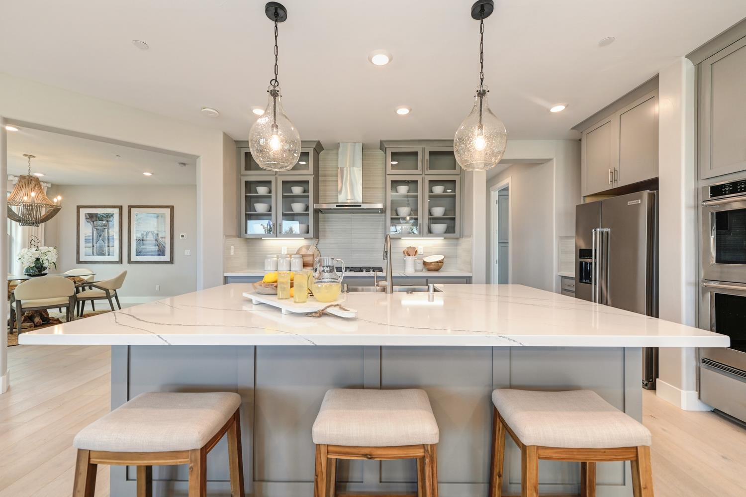 2009 Arbor Rdg Drive Roseville, CA 95747 - Photo 16 of 70 a kitchen with a dining table chairs stainless steel appliances and cabinets