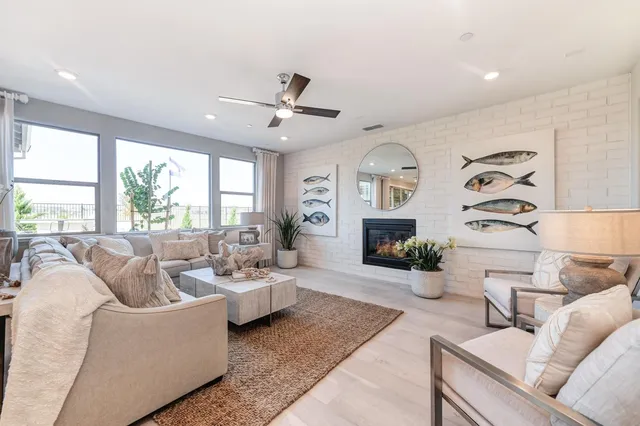 a living room with furniture windows and flat screen tv