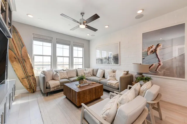 a white bath tub sitting in a bathroom next to a window
