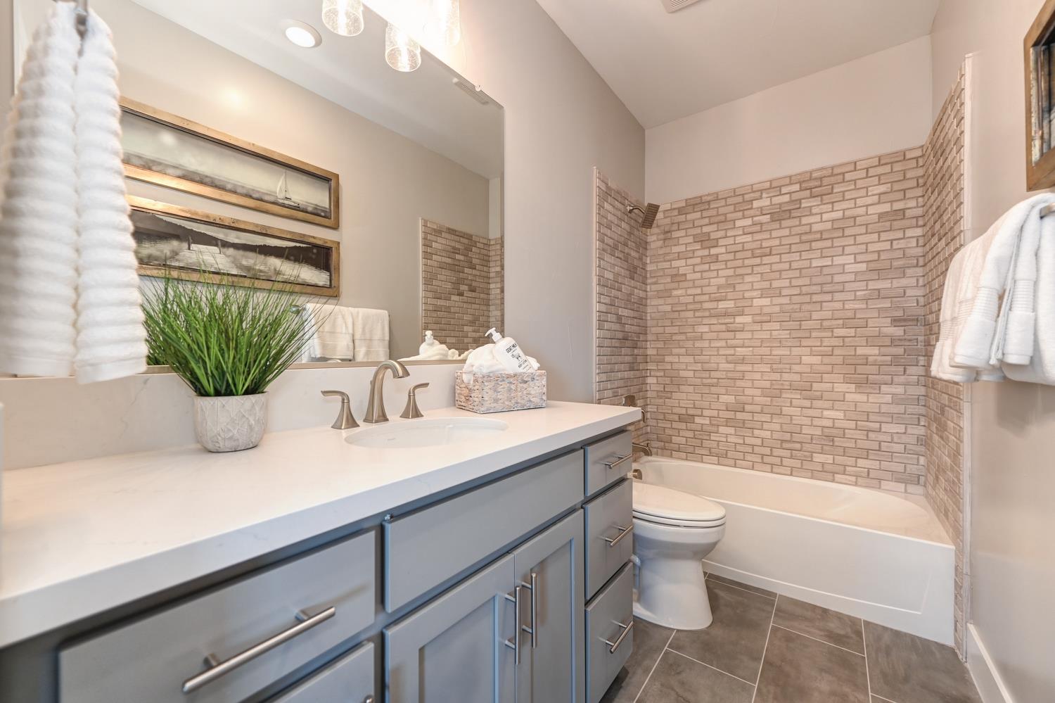2009 Arbor Rdg Drive Roseville, CA 95747 - Photo 35 of 70 a bathroom with a granite countertop sink a toilet and tub