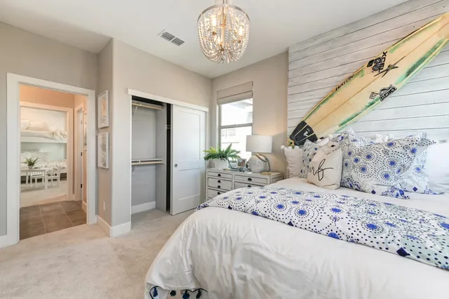 a kitchen with kitchen island a refrigerator a stove a sink and dishwasher with wooden floor