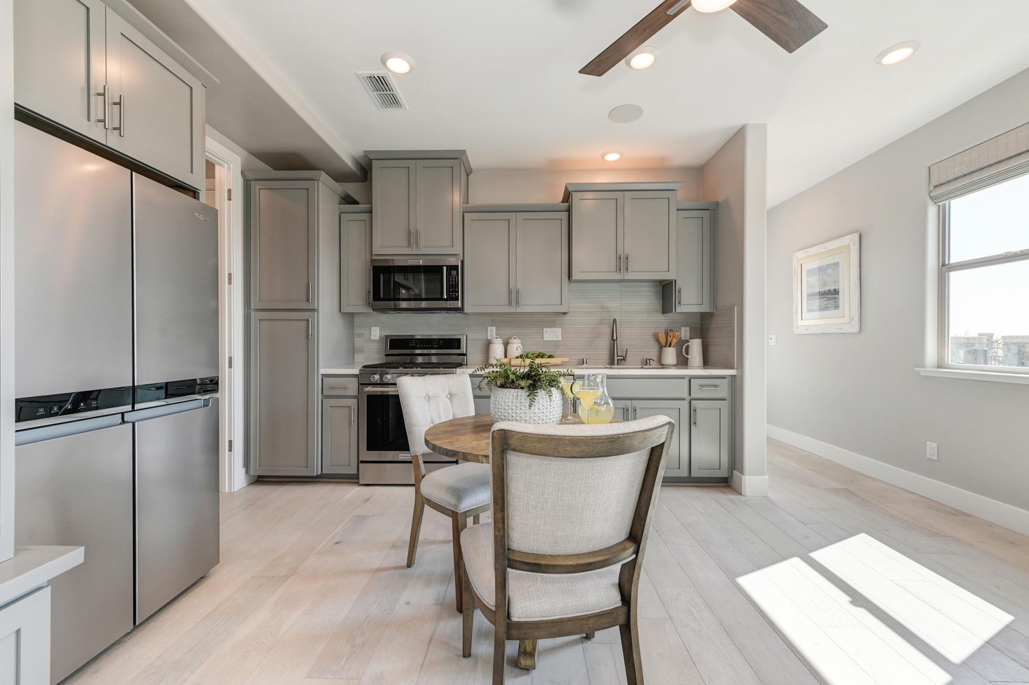 2009 Arbor Rdg Drive Roseville, CA 95747 - Photo 47 of 70 a kitchen with kitchen island a refrigerator a stove a sink and dishwasher with wooden floor