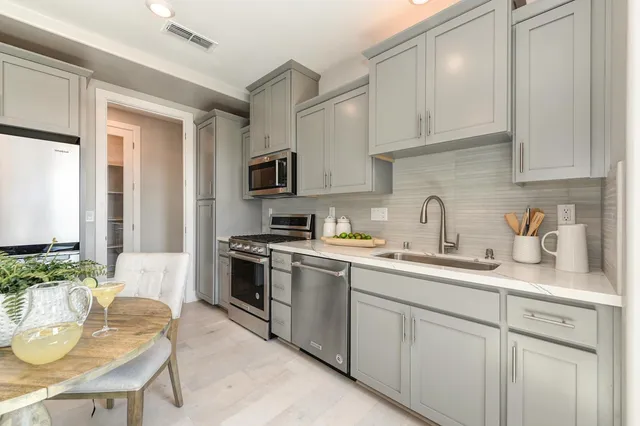 a view of a patio with couches chairs and a table and chairs with wooden floor