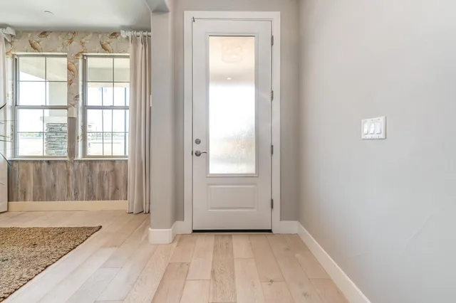 a bathroom with a toilet sink vanity and mirror