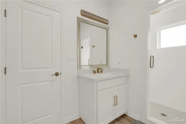 a bedroom with bed and a computer on desk chair