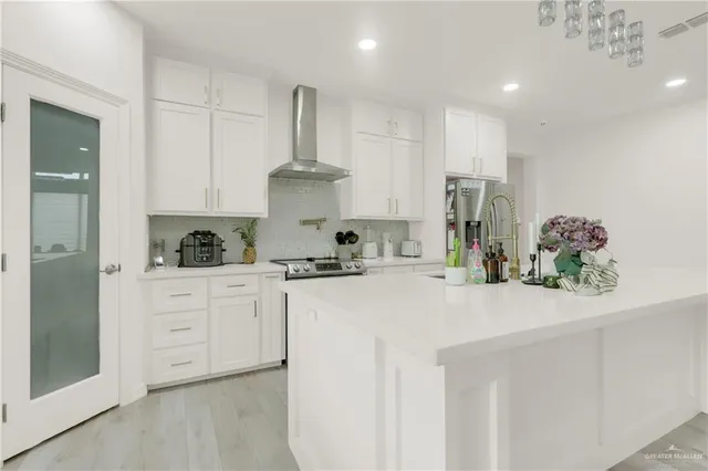 a living room with furniture and a dining table with kitchen view