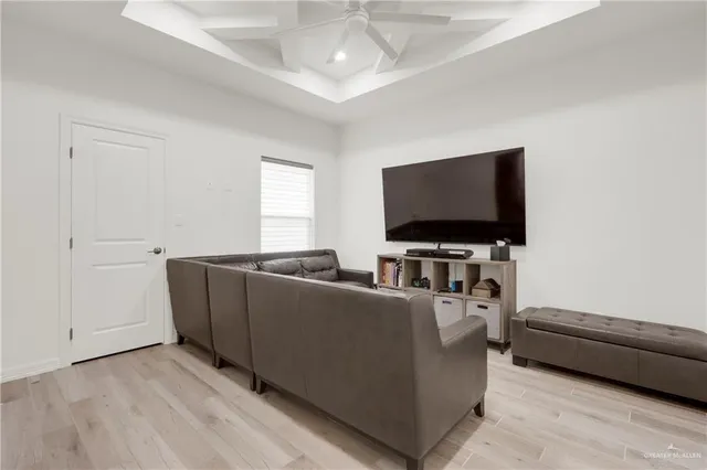 a kitchen with stainless steel appliances a refrigerator a sink dishwasher a stove and white cabinets with wooden floor