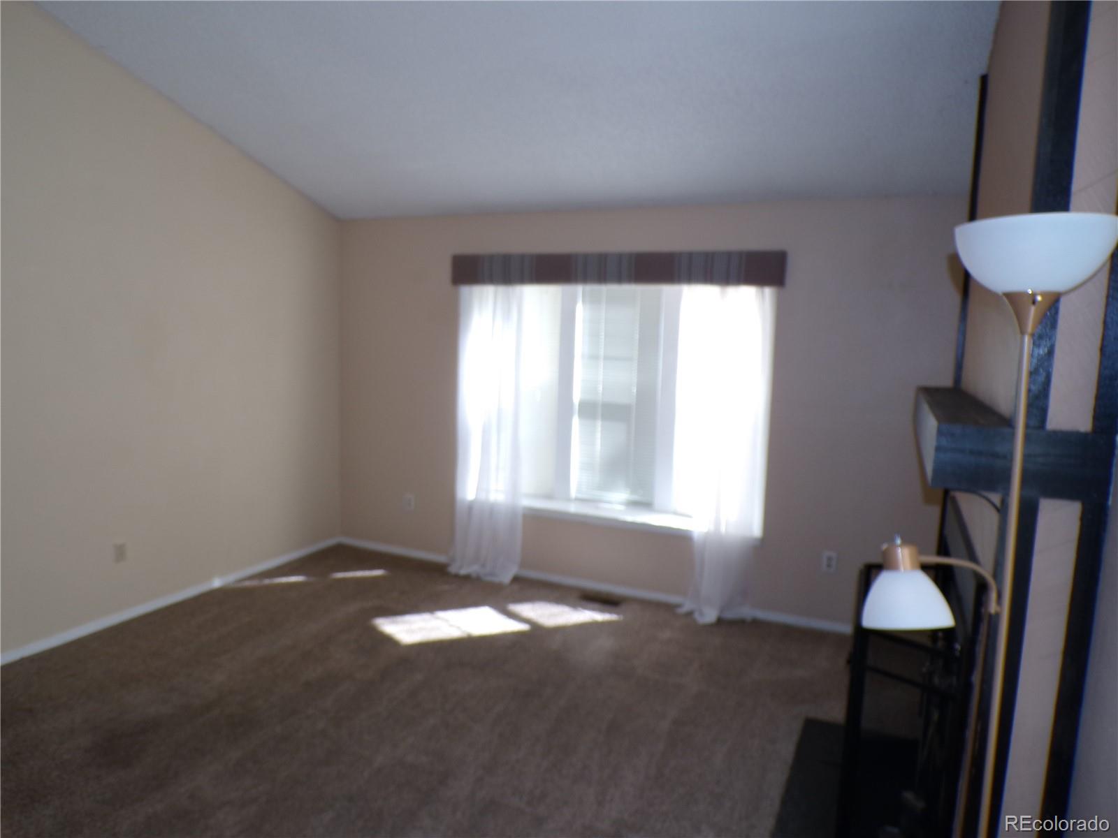 9644 West Chatfield Avenue, Unit A Littleton, CO 80128 - Photo 3 of 11 a view of an empty room with a window