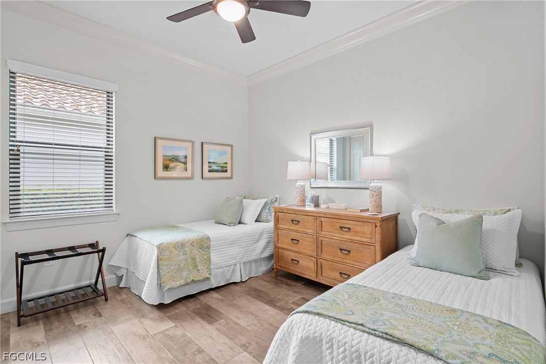 9383 Slate Court Naples, FL 34120 - Photo 17 of 28 a bedroom with a bed and a dresser