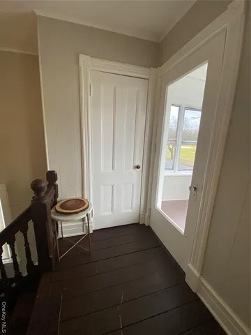 a view of a room with furniture and wooden floor