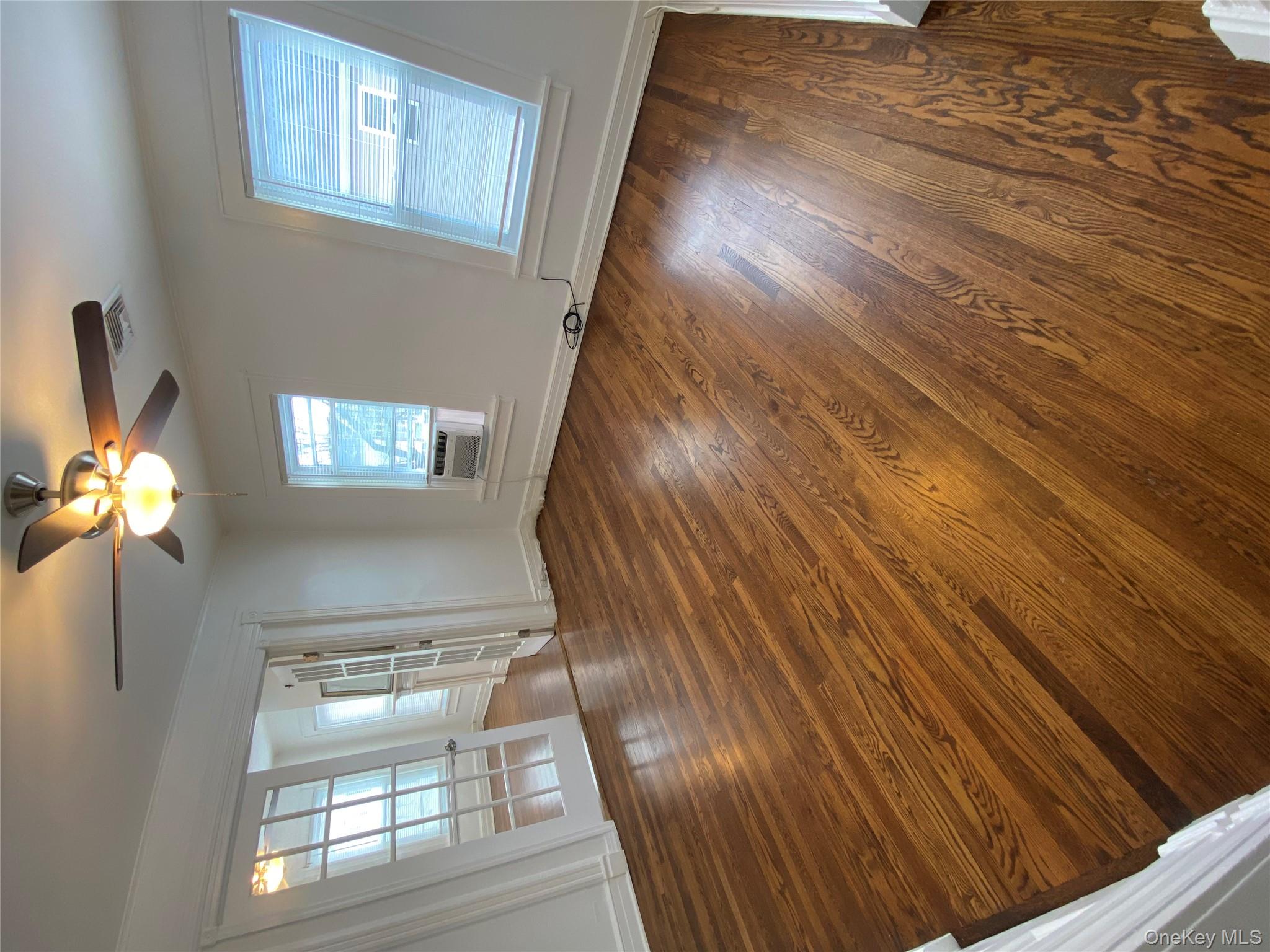 21 Lincoln Avenue, Unit 2 Poughkeepsie, NY 12601 - Photo 3 of 18 wooden floor in an empty room with a window