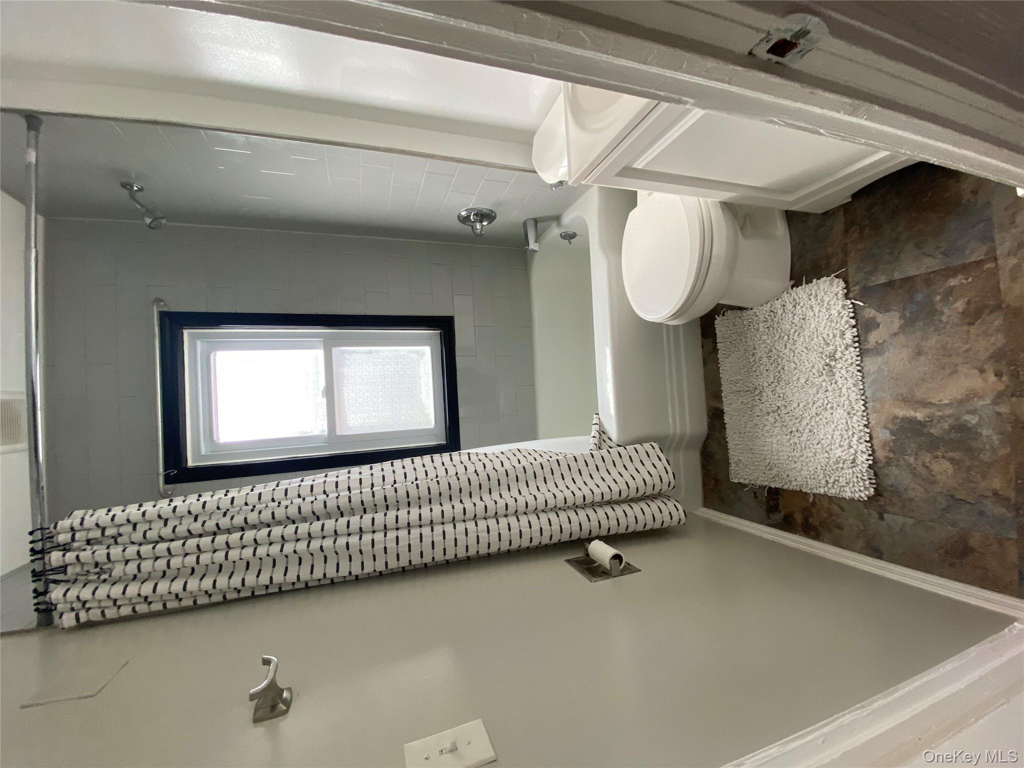 21 Lincoln Avenue, Unit 2 Poughkeepsie, NY 12601 - Photo 5 of 18 a bathroom with a toilet a sink and a bathtub