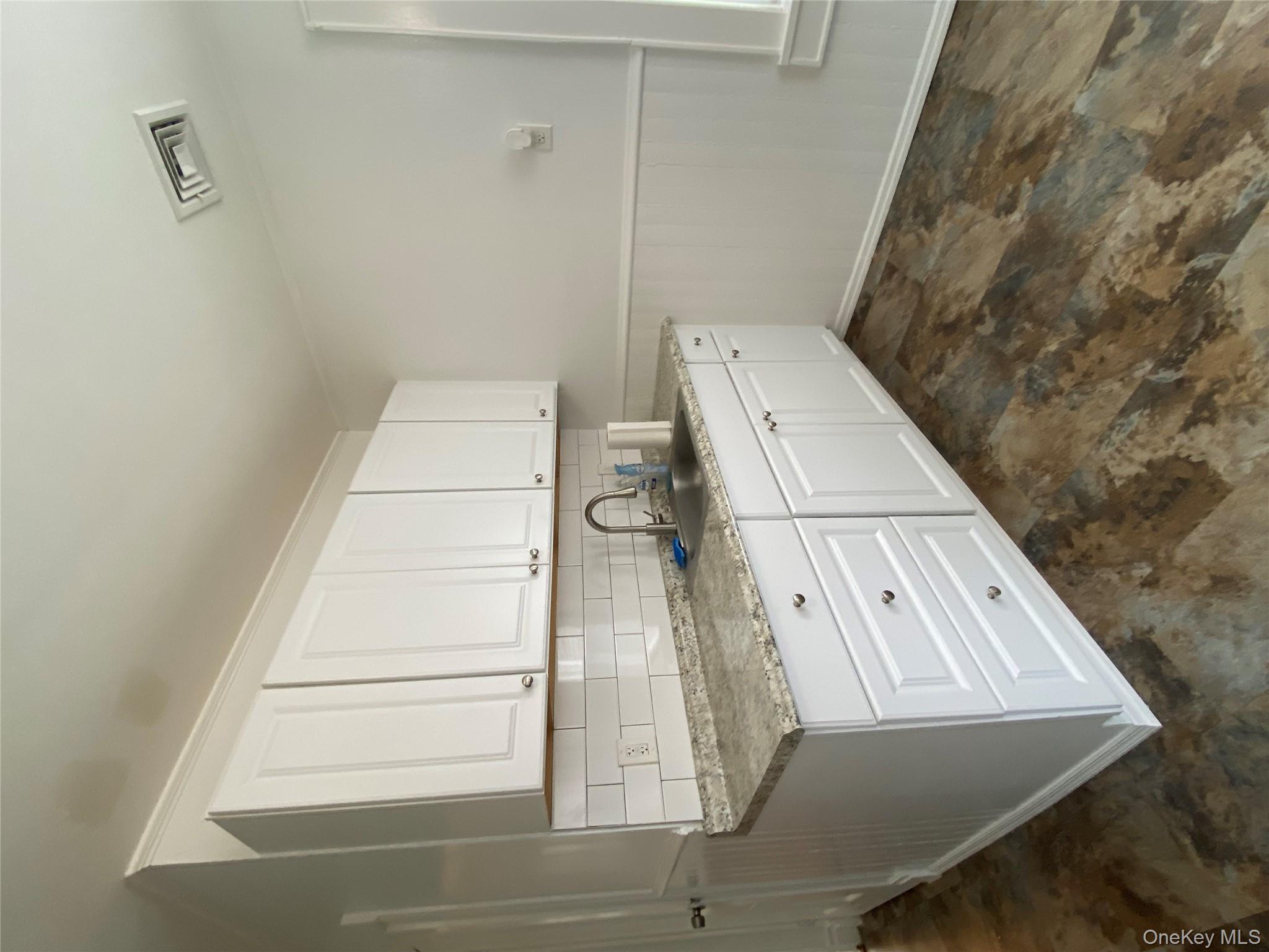 21 Lincoln Avenue, Unit 2 Poughkeepsie, NY 12601 - Photo 6 of 18 a kitchen with granite countertop white cabinets and white appliances