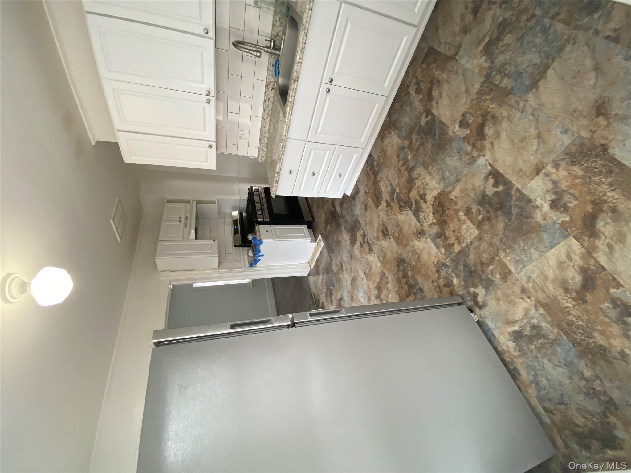 21 Lincoln Avenue, Unit 2 Poughkeepsie, NY 12601 - Photo 7 of 18 a kitchen with stainless steel appliances granite countertop a refrigerator sink and cabinets