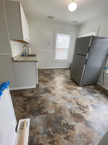 a kitchen with granite countertop a sink and a stove top oven