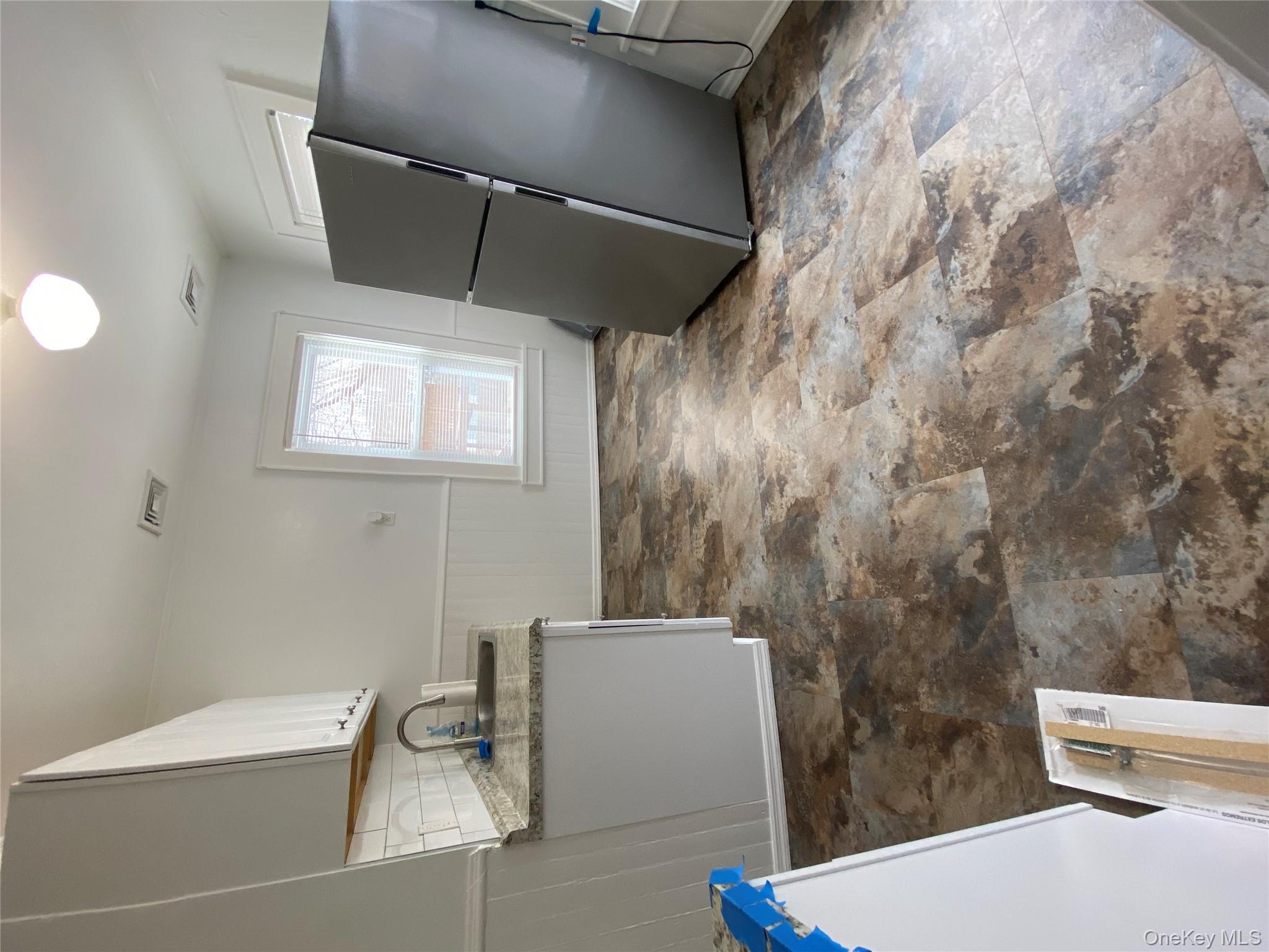 21 Lincoln Avenue, Unit 2 Poughkeepsie, NY 12601 - Photo 8 of 18 a kitchen with granite countertop a sink and a stove top oven