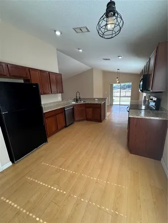 a large kitchen with a large counter top appliances and furniture