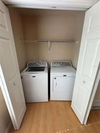 a utility room with sink dryer and washer