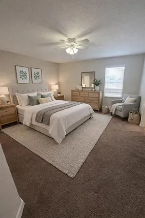 a bedroom with bed couch and window