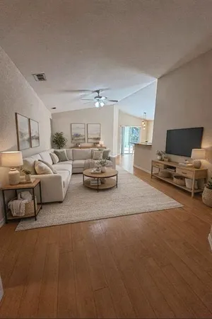 a living room with furniture and a chandelier