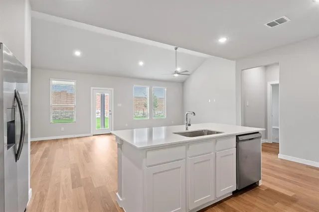 a kitchen with sink and refrigerator