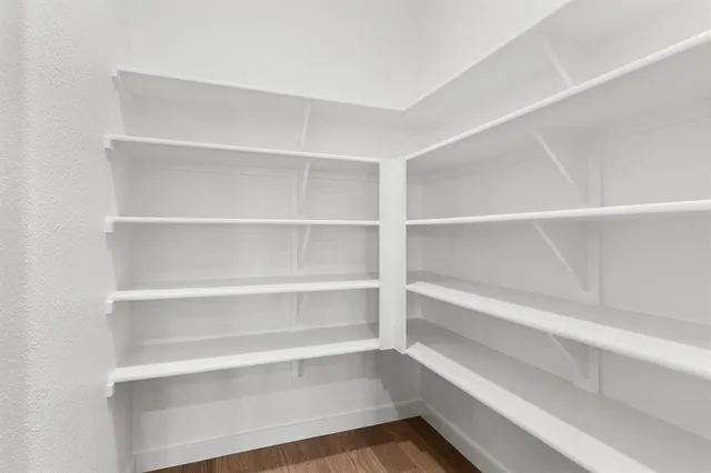 a view of walk in closet with empty racks