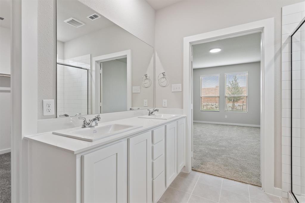 2010 Sandpiper Way Princeton, TX 75407 - Photo 17 of 40 a bathroom with a sink and a mirror