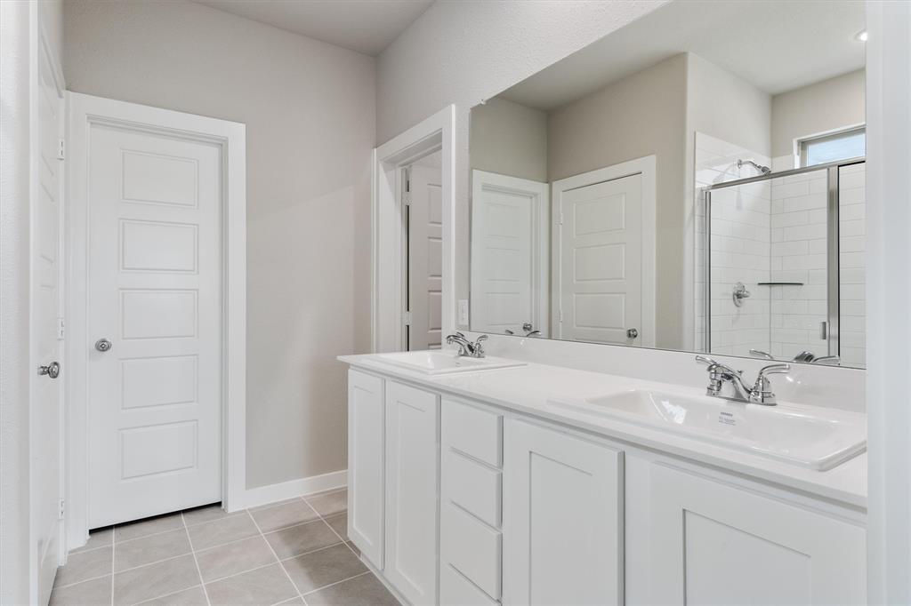 2010 Sandpiper Way Princeton, TX 75407 - Photo 18 of 40 a bathroom with a sink double vanity and a mirror