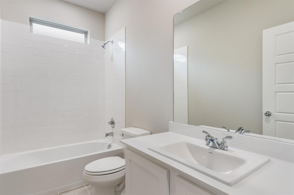 2010 Sandpiper Way Princeton, TX 75407 - Photo 21 of 40 a bathroom with a sink a toilet and shower