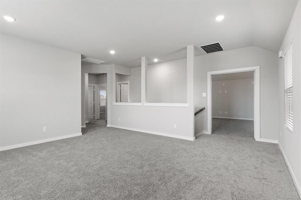 2010 Sandpiper Way Princeton, TX 75407 - Photo 25 of 40 a view of an empty room with a cabinet and a refrigerator