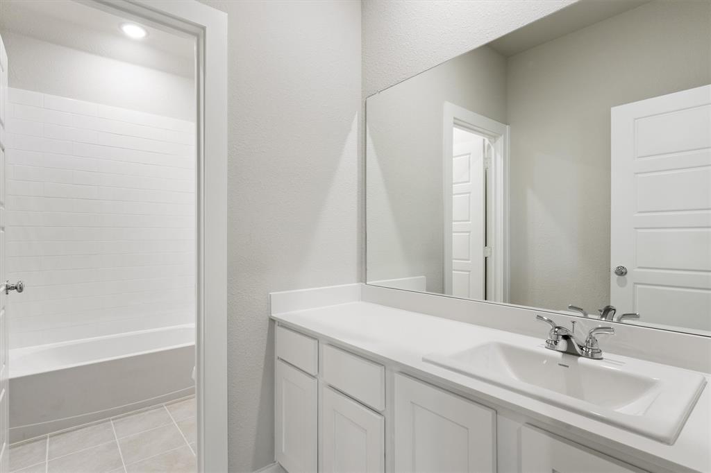 2010 Sandpiper Way Princeton, TX 75407 - Photo 30 of 40 a bathroom with a sink and a mirror