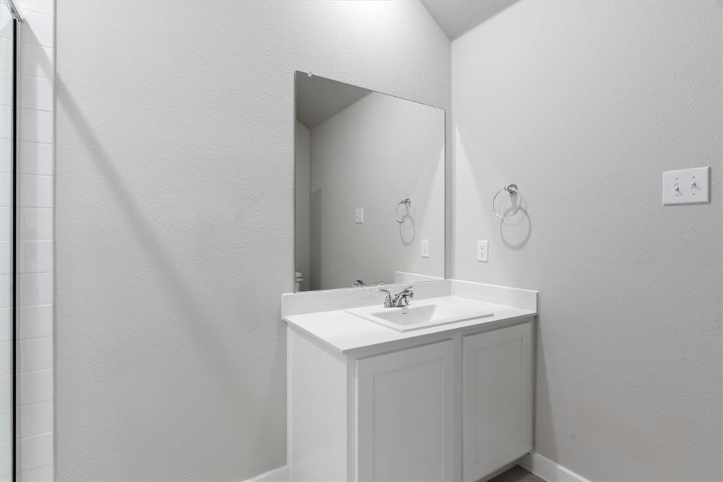 2010 Sandpiper Way Princeton, TX 75407 - Photo 33 of 40 a bathroom with a sink and a mirror