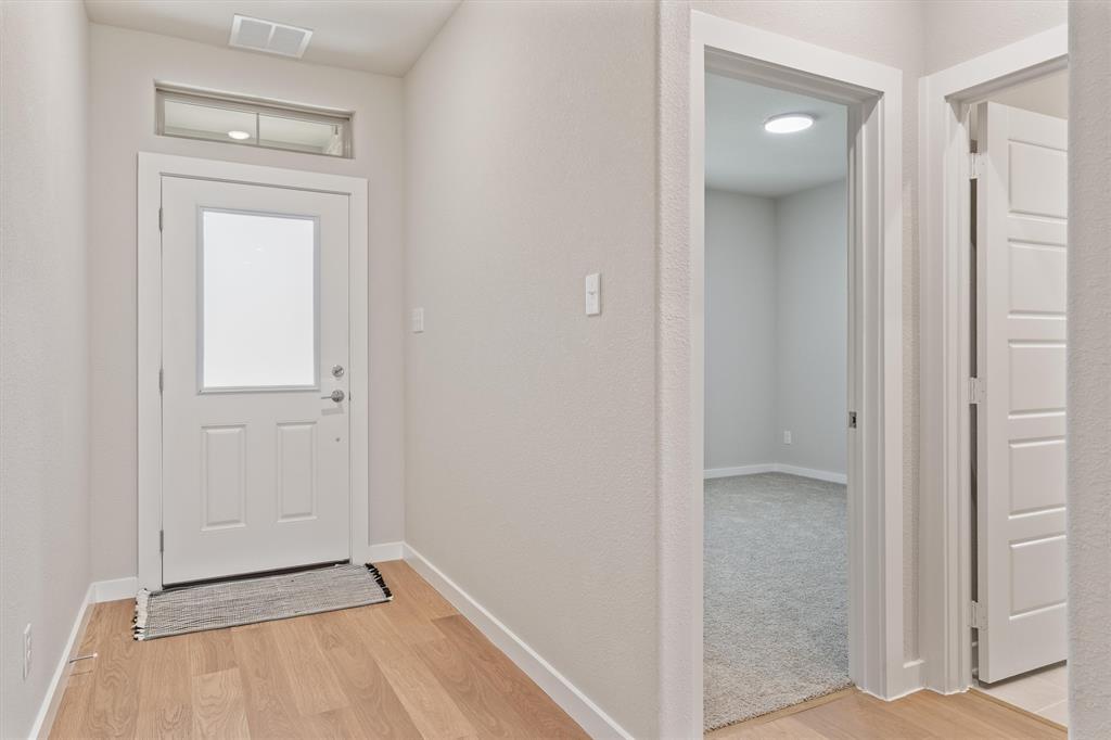 2010 Sandpiper Way Princeton, TX 75407 - Photo 5 of 40 a view of a livingroom with wooden floor and closet area