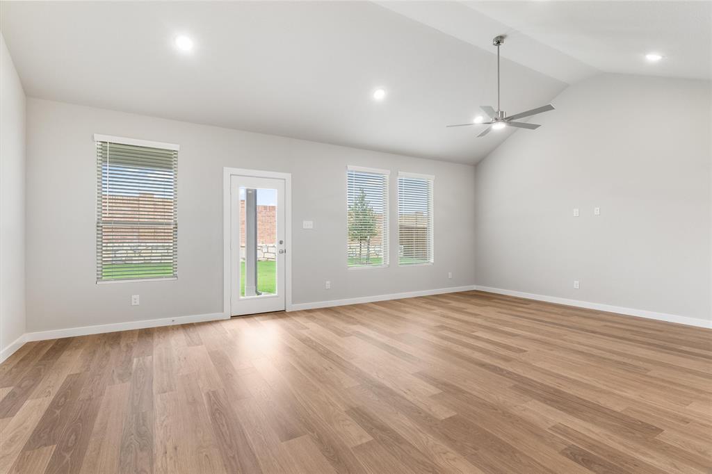 2010 Sandpiper Way Princeton, TX 75407 - Photo 6 of 40 a view of an empty room with wooden floor and a window