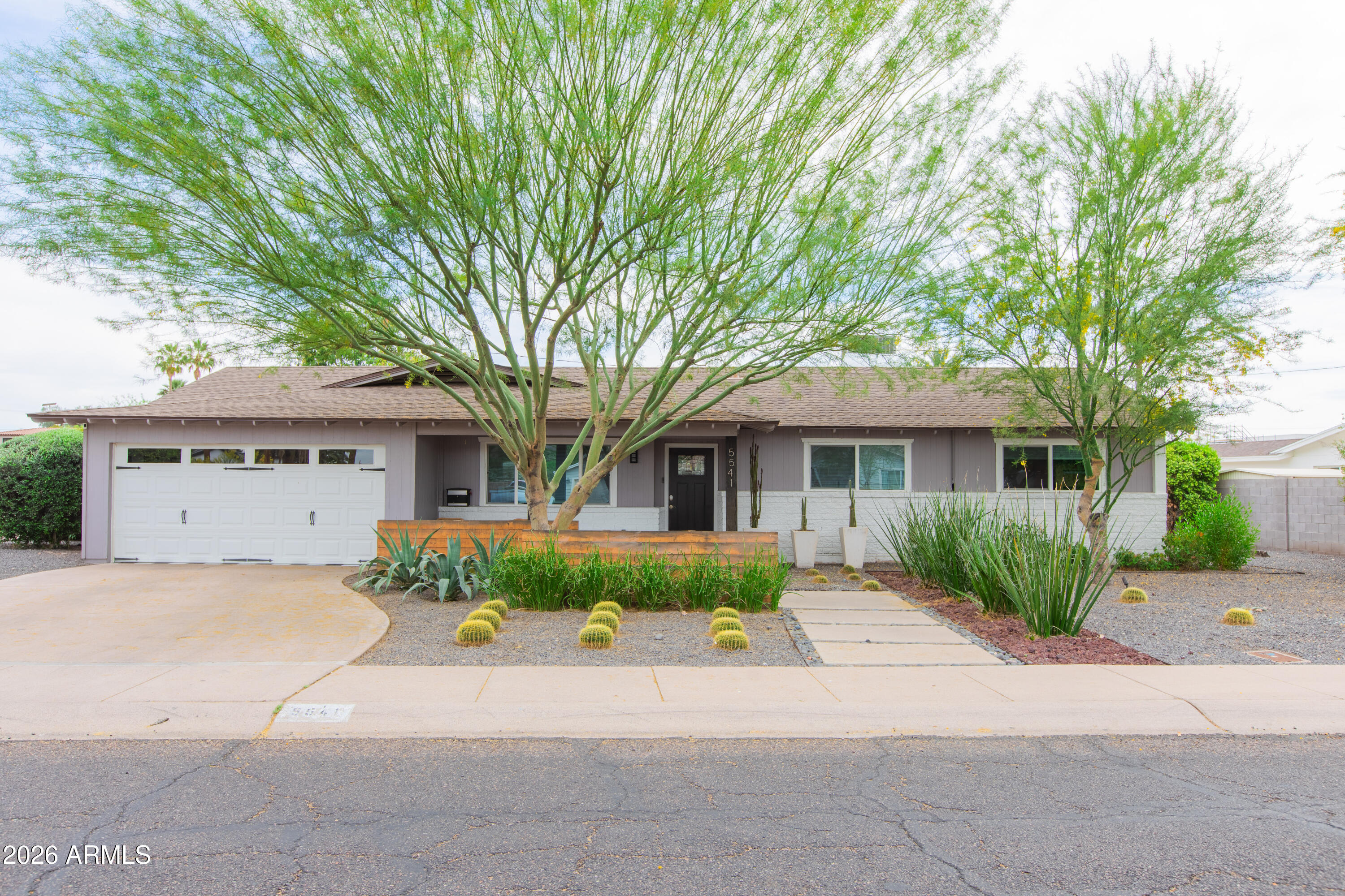 5541 East Cheery Lynn Road Phoenix, AZ 85018 - Photo 2 of 69 front view of a house with a bench and potted plants