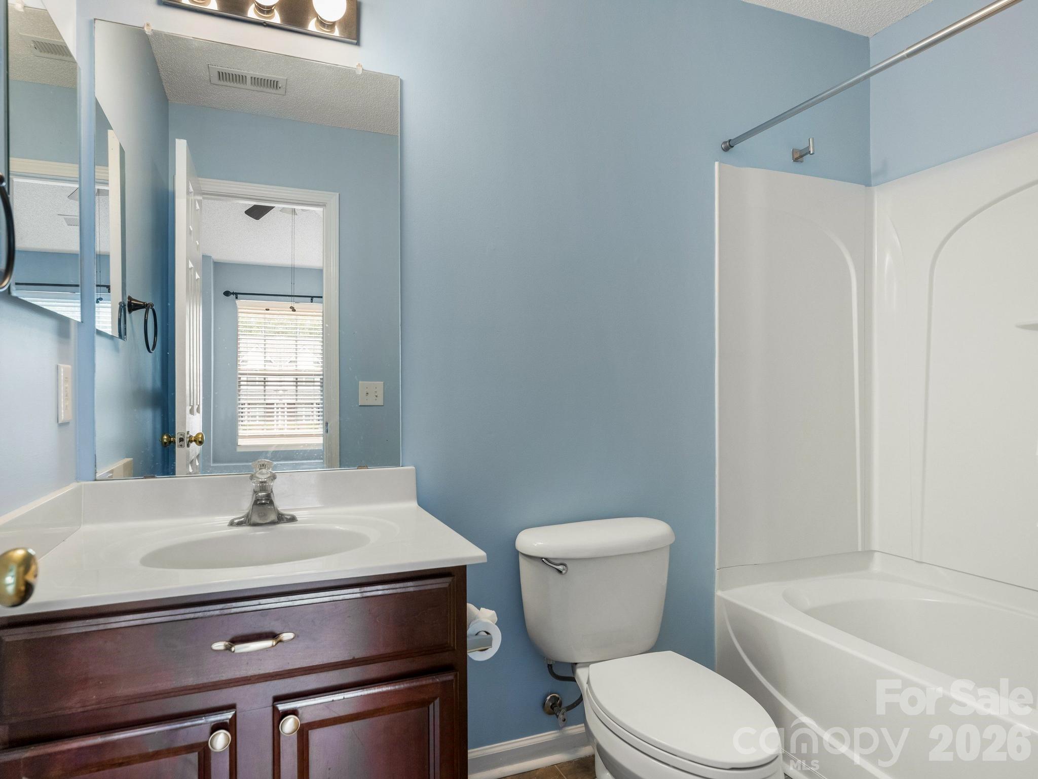 3259 Blythe Ridge Court Charlotte, NC 28213 - Photo 14 of 17 a bathroom with a sink toilet and shower