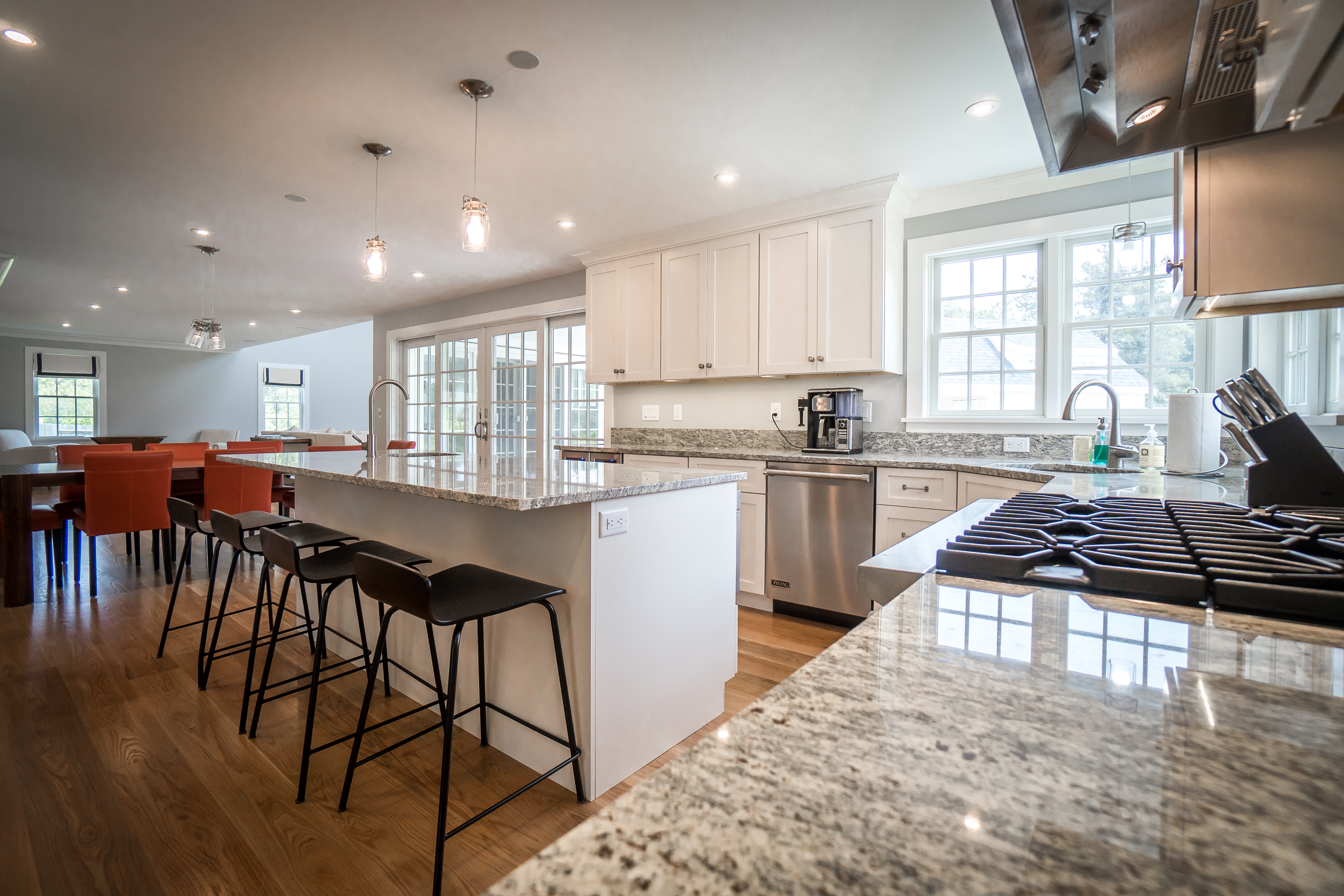 50 Lovers Lane Nantucket, MA 02554 - Photo 11 of 34 a kitchen with stainless steel appliances granite countertop a stove top oven a sink a dining table and chairs with wooden floor