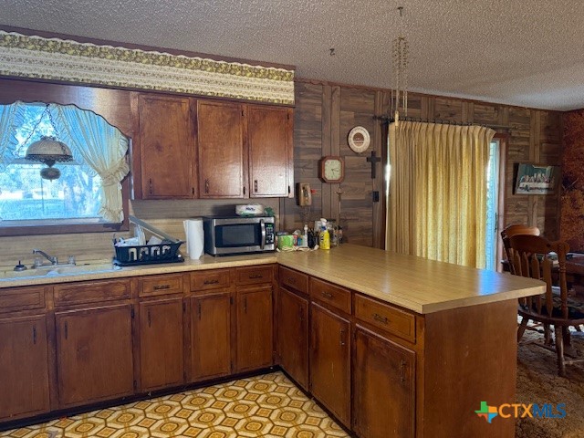 215 Price Street Yoakum, TX 77995 - Photo 9 of 20 a kitchen with stainless steel appliances granite countertop a sink a stove and a refrigerator