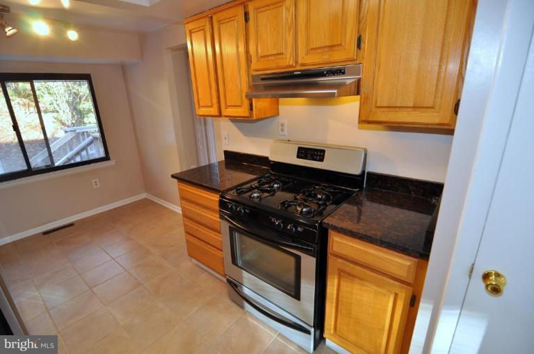 7914 Orange Plank Road Springfield, VA 22153 - Photo 6 of 9 a kitchen with stove and cabinets