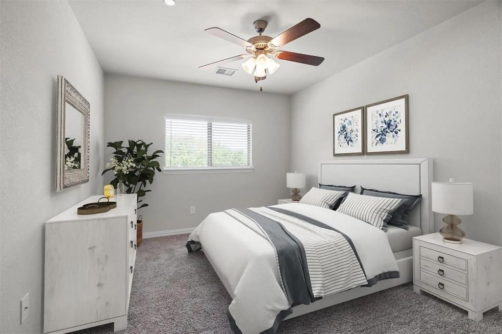 3300 Becker Drive Denton, TX 76207 - Photo 16 of 28 a bedroom with a bed and a chandelier