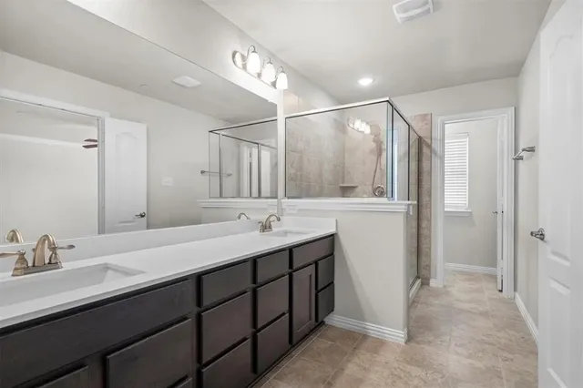 a bathroom with a double vanity sink and mirror
