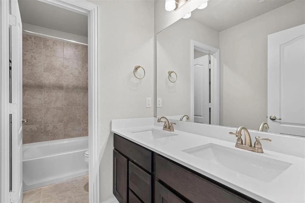 3300 Becker Drive Denton, TX 76207 - Photo 24 of 28 a bathroom with a sink and a mirror